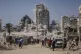 Palestinians run for cover during an Israeli airstrike on a high-rise building in Gaza City, September 5, 2025