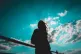 A woman looks at the sky