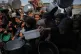 Palestinians struggle to get donated food at a community kitchen in Khan Younis, southern Gaza Strip, Sunday, Oct. 5, 2025.