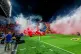 Smoke from flares thrown by fans fills the field before the soccer derby between Maccabi Tel Aviv and Hapoel Tel Aviv was called off Sunday after pregame disturbances led police to deem it unsafe to proceed at Bloomfield Stadium in Tel Aviv, Israel