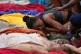 A woman mourns over the bodies of people killed the day before during a police raid targeting the Comando Vermelho gang in the Complexo da Penha favela of Rio de Janeiro, Brazil, Wednesday, Oct. 29, 2025