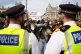 Police officers with demonstrators as people take part in a Lift the Ban on Palestine Action protest organised by Defend our Juries in Parliament Square in London, September 6, 2025