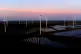 Wind turbines operate as the sun rises at the Klettwitz Nord solar energy park near Klettwitz, Germany, October 16, 2024