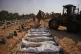 Bodies of unidentified Palestinians returned from Israel as part of the ceasefire deal are buried in a mass grave in Deir al-Balah, Gaza Strip, Wednesday, Nov. 5, 2025