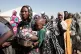 Sudanese women displaced from El-Fasher stand in line to receive food aid at the newly established El-Afadh camp in Al Dabbah, in Sudan's Northern State, Sunday, Nov. 16, 2025