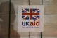 A UK aid label is attached to a box containing kitchen sets at a UK aid Disaster Response Centre at Kemble Airport, Wiltshire, December 2020
