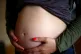 A pregnant woman holding her stomach
