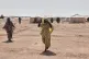 Sudanese women displaced from el-Fasher, the capital of North Darfur, and other conflict-affected areas walk through the newly established El-Afadh camp in Al Dabbah, Northern State, Sudan, November 13, 2025