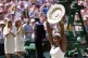 Serena Williams, of the United States, reacts as she holds up the trophy after winning the women's singles final against Garbine Muguruza of Spain, at the All England Lawn Tennis Championships in Wimbledon, London, July 11, 2015