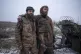 Ukrainian soldiers Denis and Dmytro hug each other after their return from a position where they fought for 130 days near Kostyantynivka, Donetsk region, Ukraine, December 16, 2025