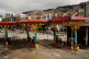 People walk past an empty gas station that ran out of fuel in La Paz, Bolivia, Thursday, Dec. 18, 2025, the day after Bolivian President Rodrigo Paz announced the end of fuel subsidies