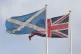 A Saltire flag and a Union flag flying above Whitehall in Westminster, London