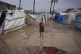 A Palestinian boy walks through an area in a temporary tent camp after heavy rainfall in Deir al-Balah, central Gaza Strip, December 12, 2025
