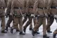 Members of the 5th Battalion, The Rifles (5 Rifles) carry their rifles as they march on the parade ground at their base at Bulford Camp, Wiltshire, December 5, 2025