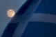 A pink supermoon is seen beside a Saltire flag in Falkirk