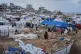 Palestinians inspect damaged tents at a displacement camp following an Israeli strike in Gaza City, January 9, 2026