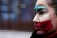 A woman, with her face painted with the colors of Iran's flag, joins with others during a small demonstration, in Istanbul, January 11, 2026, in support of the nationwide mass protests in Iran against the government
