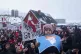 A boy holds a crossed out map of Greenland topped by a hairpiece symbolizing U.S. President Donald Trump, during a protest against Trump's policy towards Greenland in front of the US consulate in Nuuk, Greenland, January 17, 2026