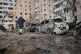 People pass by damaged cars near an apartment building after a Russian attack in Zaporizhzhia, Ukraine, January 28, 2026