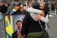 Supporters of Venezuelan President Nicolás Maduro embrace in downtown Caracas, Venezuela, January 3, 2026, after U.S. President Donald Trump announced that Maduro had been captured and flown out of the country