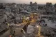 Palestinians gather for iftar, the fast-breaking meal, during the Muslim holy month of Ramadan amid the rubble of destroyed buildings in Gaza City, February 22, 2026