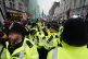 Police officers watch as people take part in a national march for Palestine on Whitehall in central London, January 18, 2025