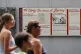 People walk past an informational panel at President's House Site, August 19, 2025, in Philadelphia