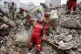 Rescue workers search for survivors in the rubble after a strike in southern Tehran, Iran, March 13, 2026