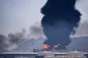 A fire and plume of smoke rise after, according to authorities. debris from an intercepted Iranian drone struck an oil facility in Fujairah, United Arab Emirates, March 14, 2026