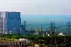 A view of Heysham Nuclear Power Station with electricity pylons in the foreground and wind turbines in the distance, July 2006