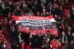 Manchester United fans in the stands hold up a banner reading MUFC Proudly Colonised By Immigrants during the Premier League match at Old Trafford, Manchester, March 1, 2026
