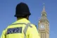 Elizabeth Tower, part of the Palace of Westminster, is seen with a Metropolitan Police officer in Parliament Square, London