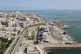 Backdropped by ships in the Strait of Hormuz, damage, according to local witnesses caused by several recent airstrikes during the U.S.-Israel military campaign, is seen on a fishing pier in the port of Qeshm island, Iran, April 13, 2026