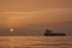 The sun rises behind tankers anchored in the Strait of Hormuz off the coast of Qeshm Island, Iran, April 18, 2026