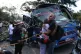 Relatives of victims embrace in front of a bus hit by an explosive device on the Pan-American Highway in Cajibio, Colombia, April 25, 2026