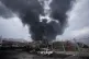 A thick plume of smoke rises from an oil storage facility hit by a US-Israeli strike in Tehran, Iran, March 8, 2026