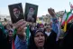 A woman holds up pictures of the Iranian Supreme Leader Ayatollah Mojtaba Khamenei, left, and his father, the slain Ayatollah Ali Khamenei in a state-organised rally, in Tehran, Iran, April 29, 2026 