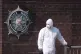 A forensic investigator at the scene in Dunmurry in Northern Ireland after a car explosion outside a police station, April 26, 2026
