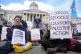 Protesters hold up placards at a demonstration against the ban on Palestine Action, in Trafalgar Square, central London, April 11, 2026