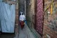 Health workers walk through an ally to administrate polio vaccine among children at a neighbourhood in Lahore, Pakistan, April 13, 2026