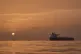 The sun rises behind tankers anchored in the Strait of Hormuz off the coast of Qeshm Island, Iran, April 18, 2026