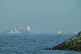 An Emirati patrol boat, left, is near a tanker anchored in the Gulf of Oman near the Strait of Hormuz, as seen from a coastal road near Khor Fakkan, United Arab Emirates, May 1, 2026