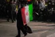 A woman carries an Iranian flag during a pro-government gathering at Enqelab-e-Eslami, or Islamic Revolution, square in Tehran, Iran, May 4, 2026