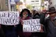 Anti-government protesters hold signs reading in Spanish 