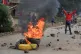 A man demonstrates near a fire during a public transport strike over fuel prices in Nairobi, Kenya, May 18, 2026