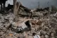 A man inspects his damaged car amid the rubble of shops destroyed in previous Israeli airstrikes in the Hosh neighborhood of Tyre, southern Lebanon, April 19, 2026