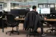An office worker at desk and monitors