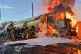 In this photo, provided by the Ukrainian Emergency Service, emergency services personnel work to extinguish a fire a vehicle following a Russian drone attack in Kyiv region, Ukraine, May 5, 2026