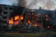 Rescue workers try to put out a fire at a residential building after a Russian strike on Kyiv, Ukraine, May 24, 2026