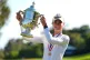 Nelly Korda holds the trophy after winning the U.S. Women's Open golf tournament, June 7, 2026, in the Pacific Palisades area of Los Angeles